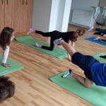 Grupa uczniów wykonuje na matach ćwiczenie