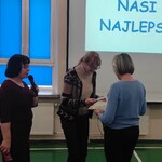 Pani vicedyrektor wręcza podziękowanie mamie uczennicy. Obok stoi pedagog.