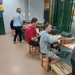 Uczniowie siedzą przy stanowiskach strzelniczych