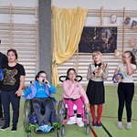 Nauczycielka i grupa uczniów w trakcie występu.
