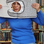 Pani bibliotekarka pokazuje książkę w kształcie krokodyla.