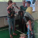 Uczniowie podają nauczycielce części garderoby