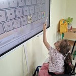 Uczennica rozwiązuje zadanie przy tablicy interaktywnej