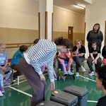 Uczennica segreguje śmieci, wrzuca plastikowe opakowanie do odpowiedniego kosza