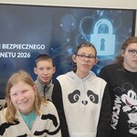 Grupa uczniów na tle wyświetlanego slajdu z napisem Dzień Bezpiecznego Internetu 2026