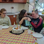 Nauczycielka składa życzenia uczniowi. Obok siedzą uczennice