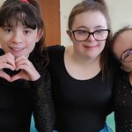 Trzy uśmiechnięte dziewczyny. w czarnych bluzkach.