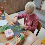 Uczennica obiera ogórek.