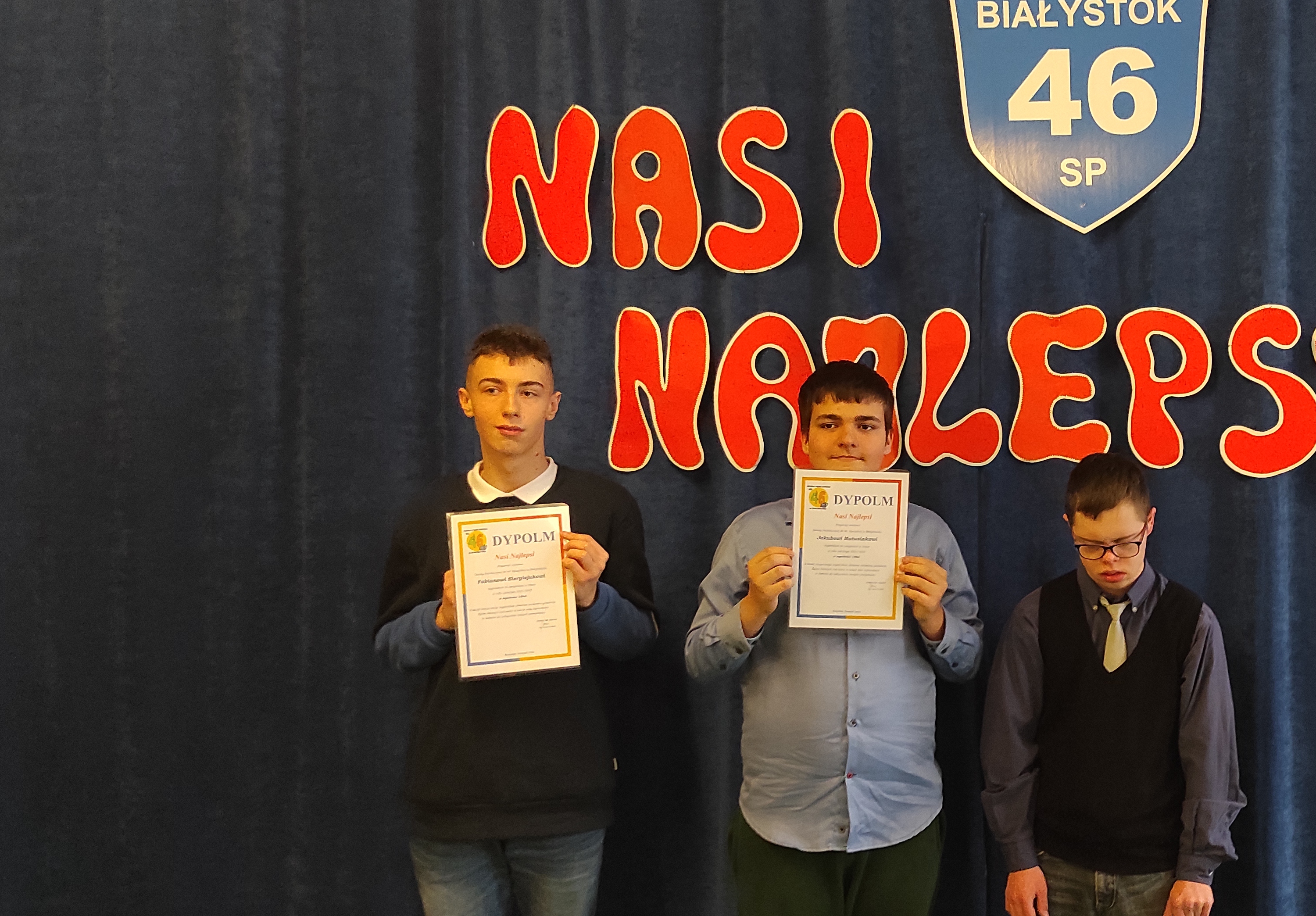 Trzech laureatów stypendium na tle napisu Nasi Najlepsi