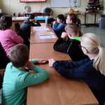 Uczniowie oglądają bajkę edukacyjną o piramidzie żywienia.